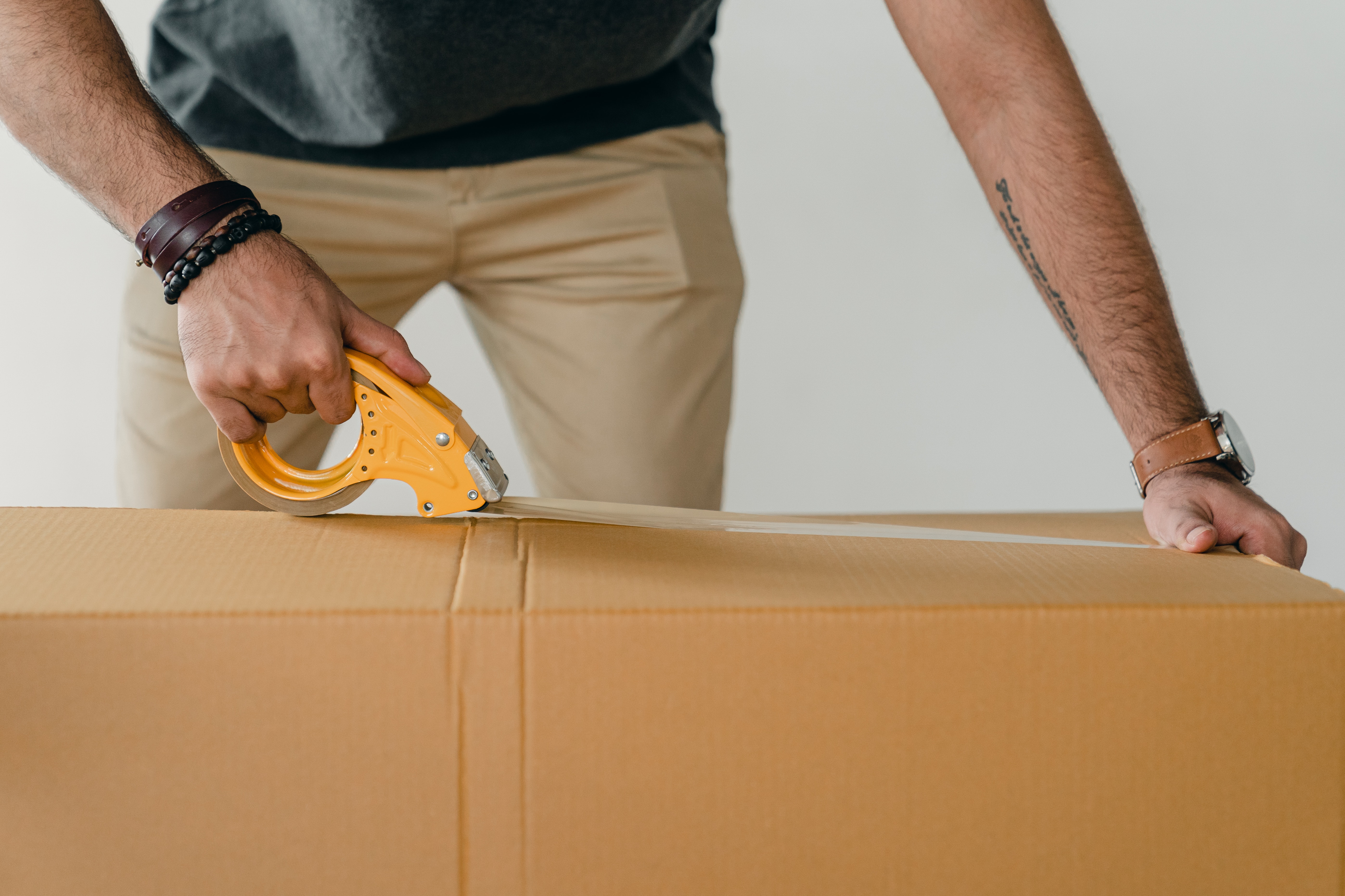 Man Taping Storage Boxes